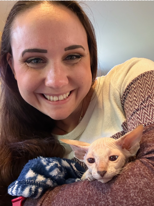 Cheyenne, veterinary technician, holding a cat