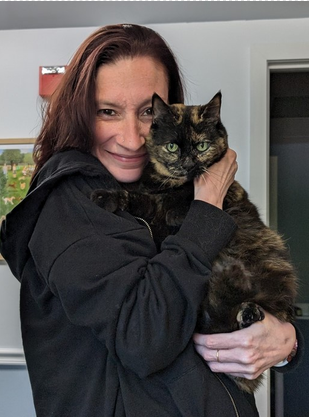 Karen, veterinary technician, holding a cat